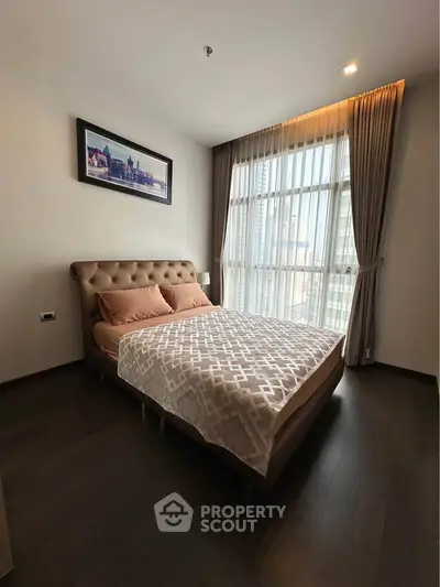 Elegant bedroom with large window and stylish decor in modern apartment