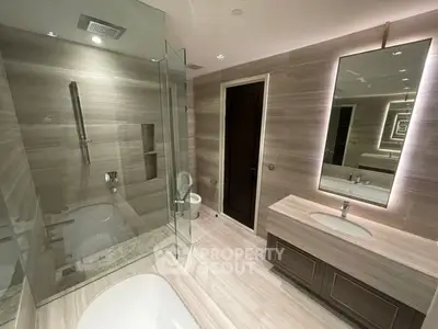 Luxurious modern bathroom with glass shower and elegant vanity
