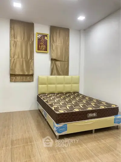 Spacious bedroom with modern decor and comfortable bed in a stylish apartment.