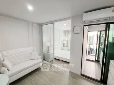 Modern apartment interior with elegant white furniture and balcony view