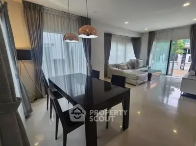 Spacious modern living room with elegant dining area and large windows