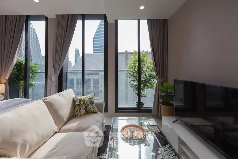 Modern living room with large windows offering city views, stylish decor, and comfortable seating.