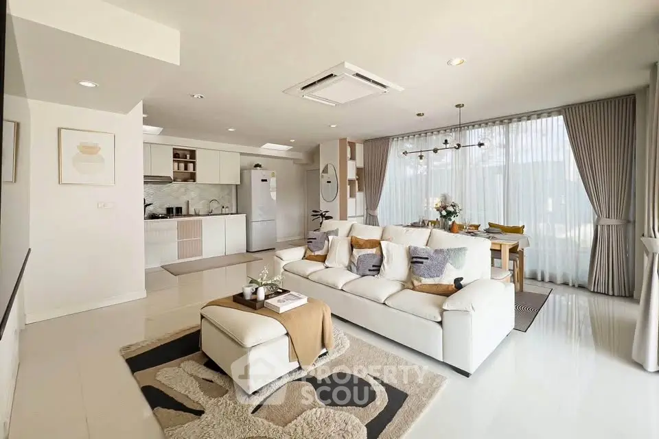 Spacious modern living room with open kitchen and elegant decor