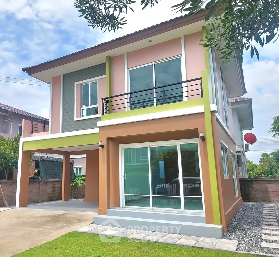 Modern two-story house with large windows and a spacious driveway