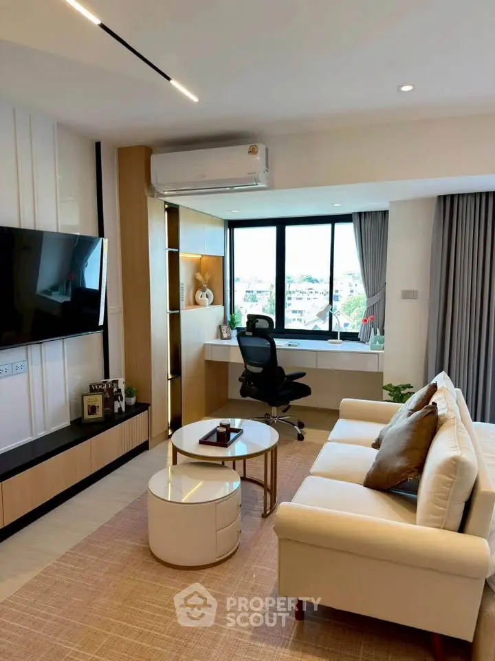 Modern living room with cozy sofa, stylish decor, and a scenic window view, perfect for urban living.
