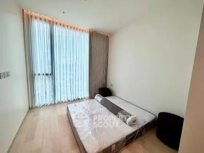 Spacious bedroom with floor-to-ceiling windows and minimalist decor