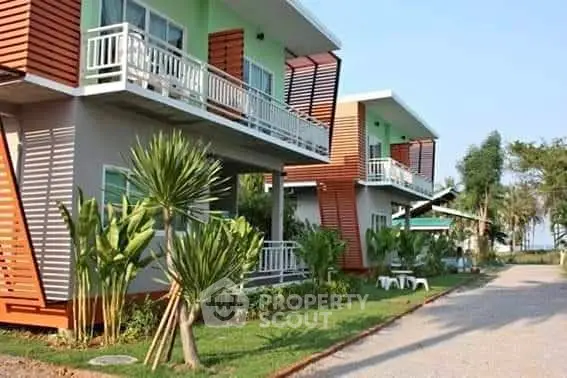 Modern duplex with unique architectural design and lush landscaping