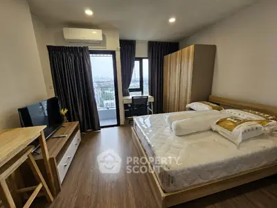 Modern bedroom with city view, featuring stylish furniture and natural light.