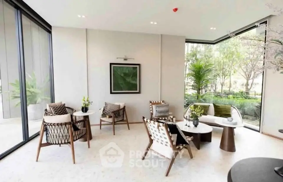 Elegant modern living room with large windows and stylish furniture, offering a serene garden view.