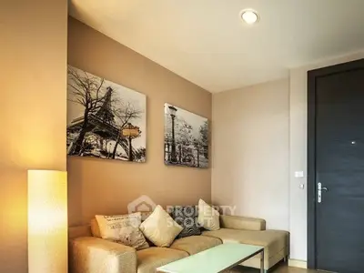 Cozy living room with modern decor and comfortable seating in a stylish apartment.