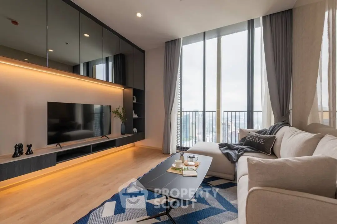 Modern living room with large windows and stylish decor in high-rise apartment.