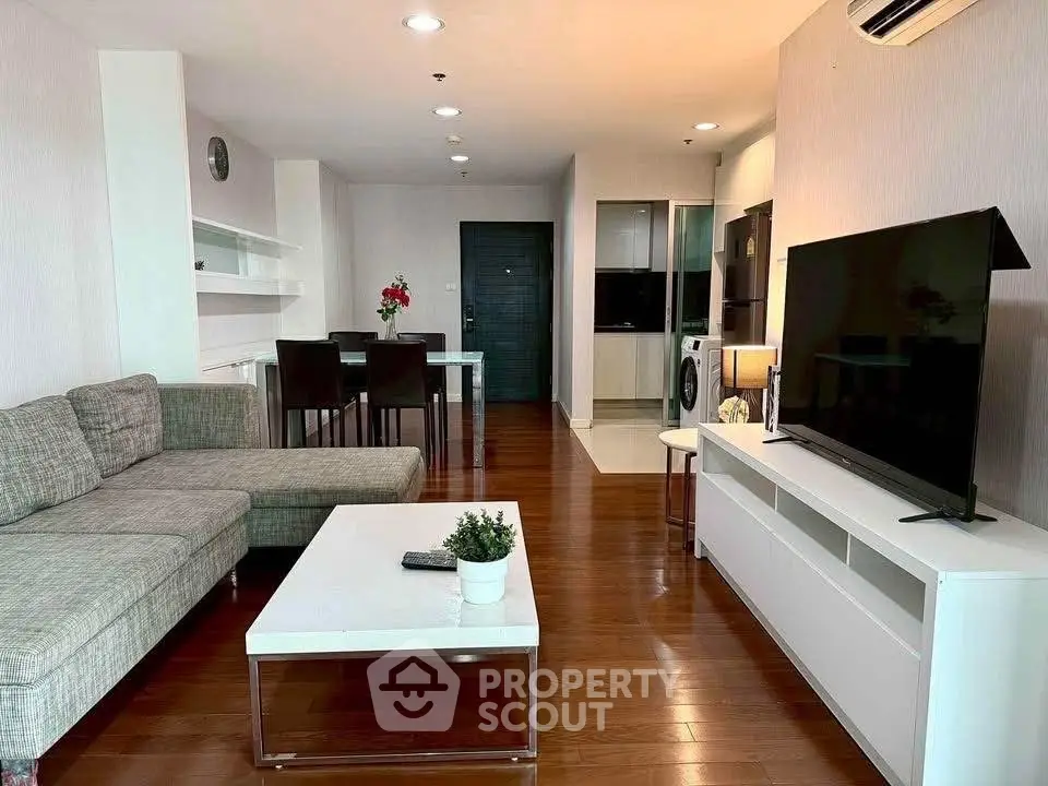 Spacious modern living room with sleek furniture and open layout, perfect for entertaining.