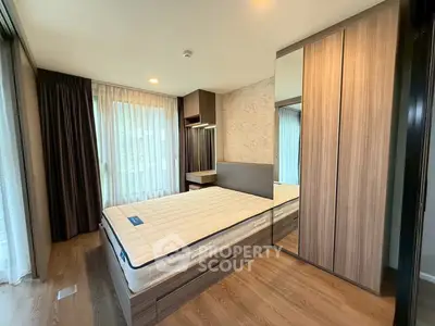 Modern bedroom with large windows and stylish wooden wardrobe