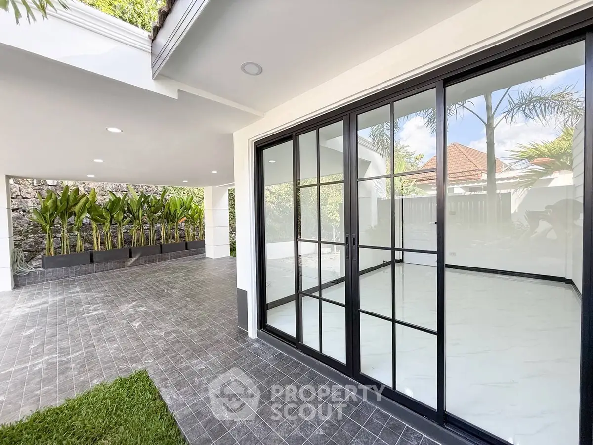 Modern home with sleek glass doors and spacious outdoor area