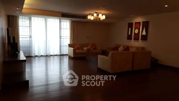 Spacious living room with elegant decor and large windows for natural light.