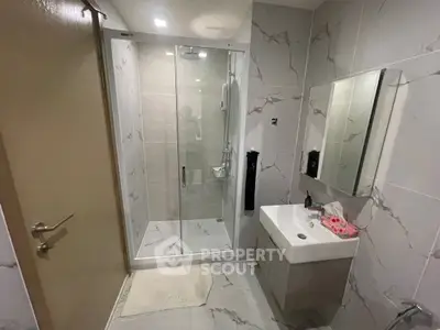Modern bathroom with sleek shower and elegant marble tiles