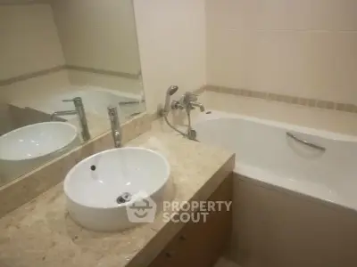 Modern bathroom with elegant marble countertop and built-in bathtub