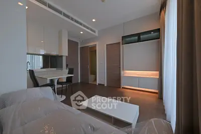 Modern living room with sleek design and open kitchen layout in luxury apartment