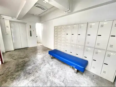 Modern building interior with lockers and blue bench, ideal for storage solutions.