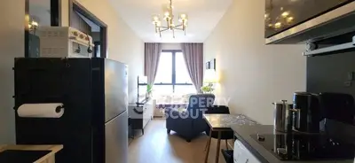 Modern apartment interior with cozy living room and compact kitchen, featuring stylish lighting and natural light.
