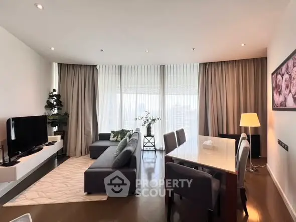 Spacious modern living room with elegant decor and large windows.