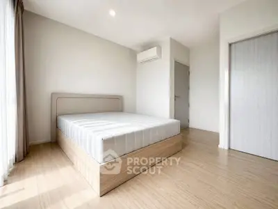 Spacious minimalist bedroom with natural light and modern design