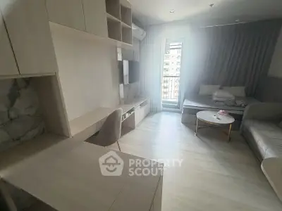 Modern living room with sleek furniture and natural light, featuring a cozy seating area and stylish decor.