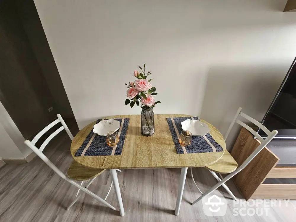 Charming dining area with wooden table and elegant floral centerpiece