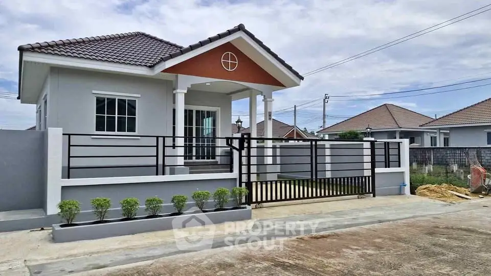 Charming single-story house with modern design and gated entrance in a serene neighborhood.