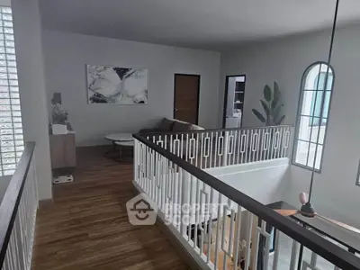Elegant upper floor hallway with modern decor and natural light