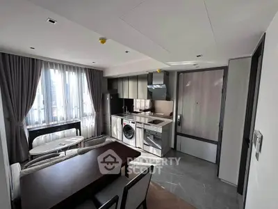 Modern open-plan kitchen and living area with sleek appliances and natural light.