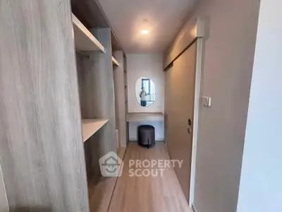 Spacious walk-in closet with modern design and ample storage space in a contemporary apartment.
