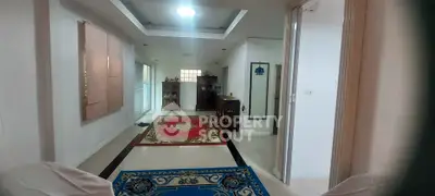 Spacious living room with elegant decor and vibrant rugs, showcasing a modern and inviting atmosphere.