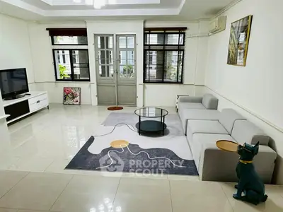 Spacious living room with modern decor and large windows for natural light.