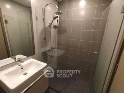Modern bathroom with glass shower enclosure and sleek sink design