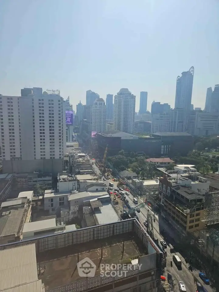 Stunning cityscape view from high-rise building showcasing urban skyline and bustling streets below.