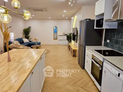 Modern open-plan kitchen and living room with stylish decor and appliances