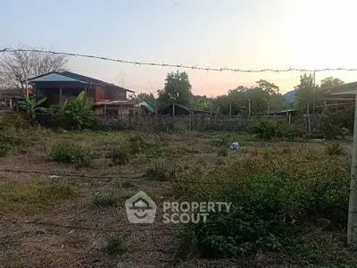 Spacious plot of land with potential for development, surrounded by greenery and a serene environment.