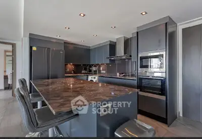 Luxurious modern kitchen with sleek black cabinetry and marble countertops