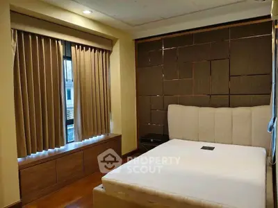 Modern bedroom with stylish wall paneling and large window