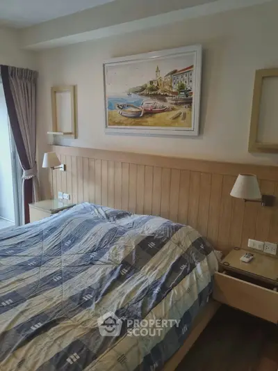 Cozy bedroom with wooden accents and scenic artwork, perfect for relaxation.
