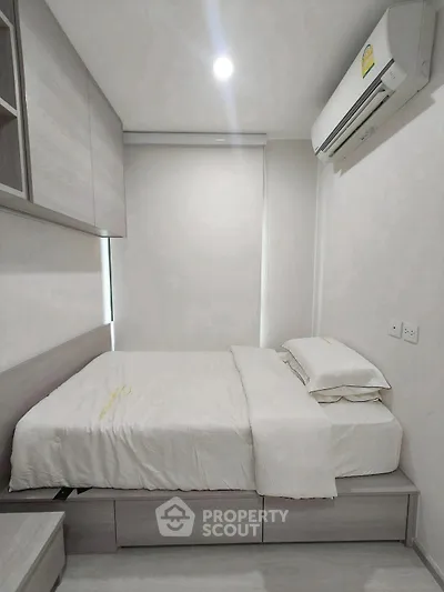 Modern minimalist bedroom with sleek design and air conditioning