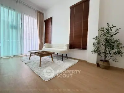Spacious living room with modern decor and large windows for natural light.