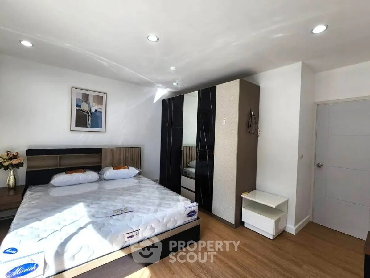 Spacious bedroom with modern decor and ample natural light