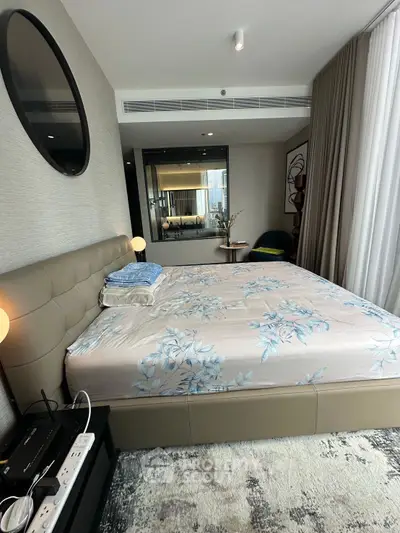 Luxurious bedroom with modern decor and large mirror, perfect for relaxation.