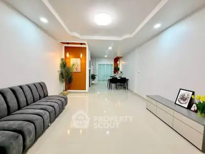 Spacious modern living room with sleek furniture and elegant lighting