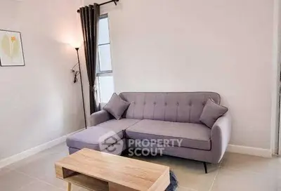 Modern living room with stylish purple sofa and natural light