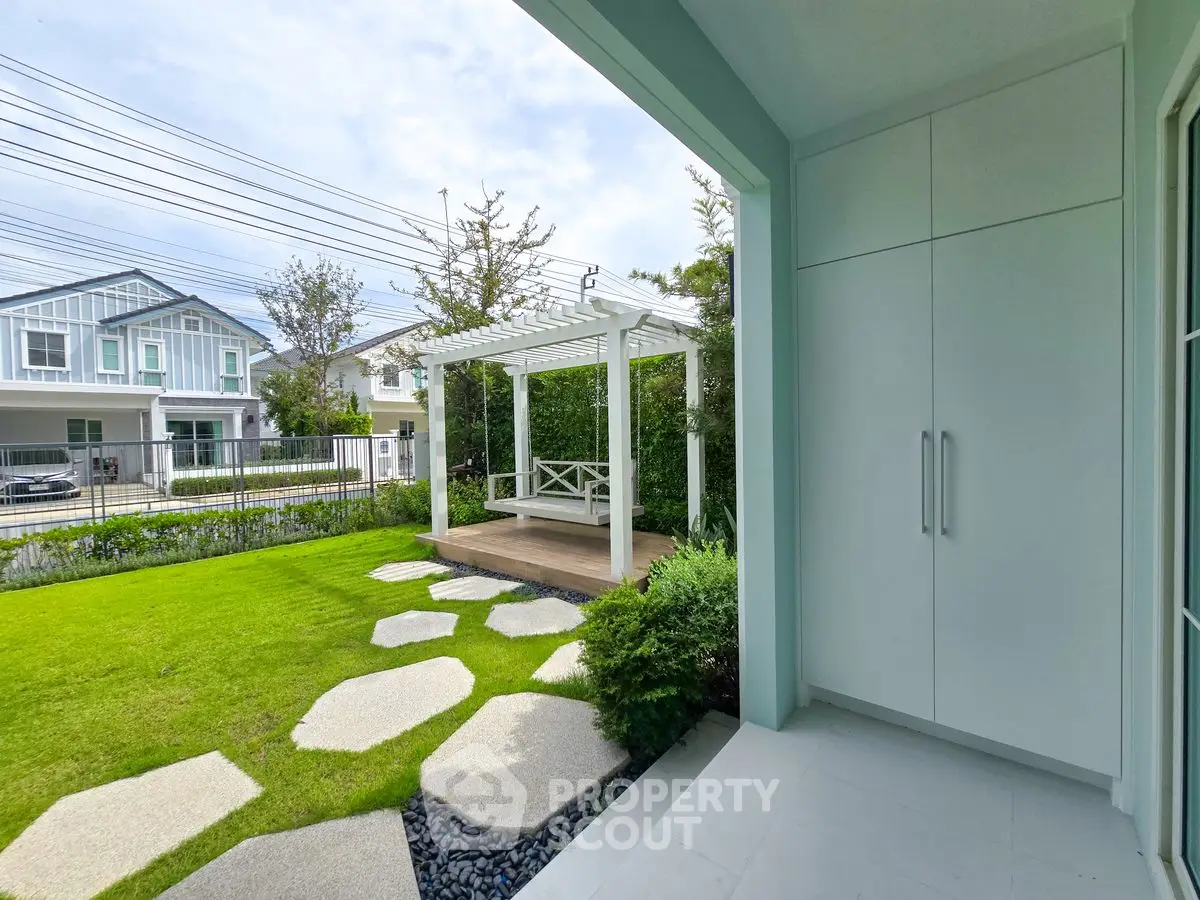Charming garden view with modern pergola and lush green lawn in suburban home