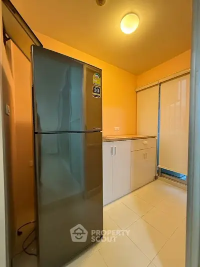 Modern kitchen with sleek fridge and ample storage space