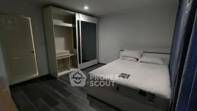 Cozy bedroom with modern wardrobe and comfortable bed in stylish apartment.